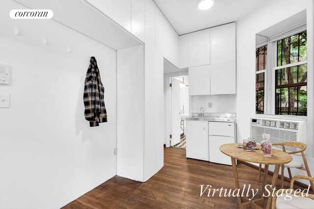 198 E 7th St Unit 1, New York City, NY 10009 - kitchen featuring stainless steel counters, dark wood-style floors, modern cabinets, a sink, and white cabinetry