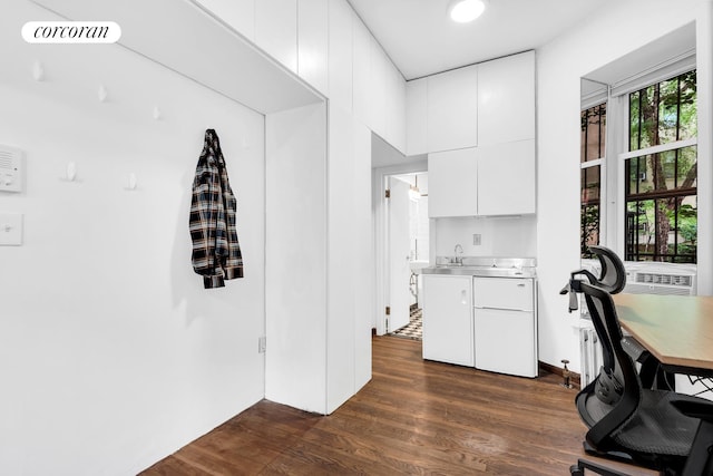 198 E 7th St Unit 1, New York City, NY 10009 - kitchen with stainless steel countertops, dark wood-style floors, white cabinetry, modern cabinets, and fridge