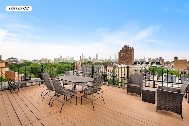 198 E 7th St Unit 1, New York City, NY 10009 - wooden deck with a view of skyline and outdoor dining area