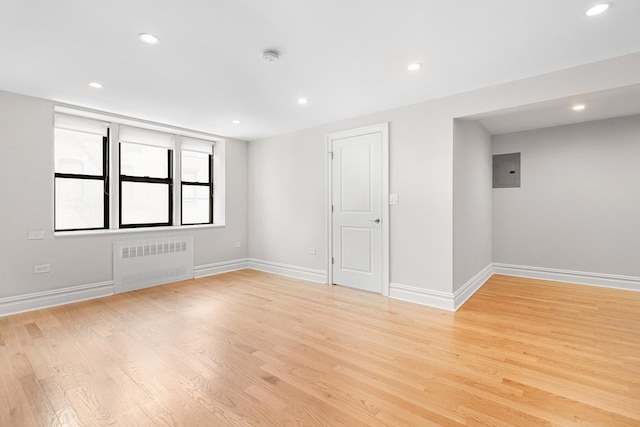 69 Bennett Ave Unit 308, New York City, NY 10033 - unfurnished room with radiator heating unit, recessed lighting, light wood finished floors, and electric panel