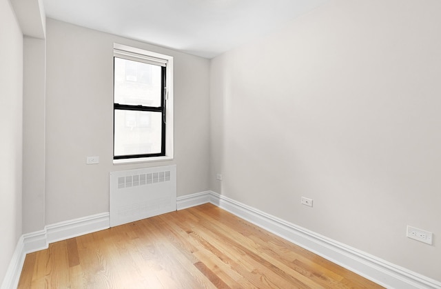 69 Bennett Ave Unit 308, New York City, NY 10033 - spare room featuring radiator heating unit and light wood-style floors