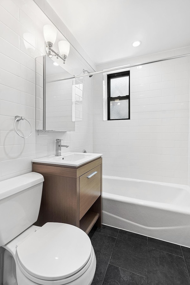 69 Bennett Ave Unit 308, New York City, NY 10033 - full bathroom with tile patterned floors, vanity, bathing tub / shower combination, and tile walls