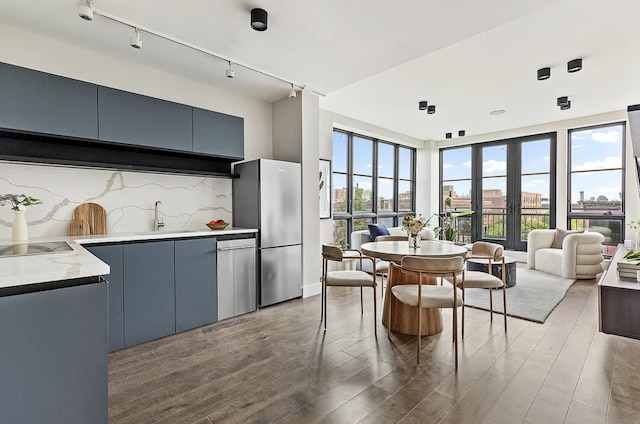 1411 Bushwick Ave Unit 4A, New York City, NY 11207 - kitchen featuring appliances with stainless steel finishes, wood finished floors, tasteful backsplash, and a sink