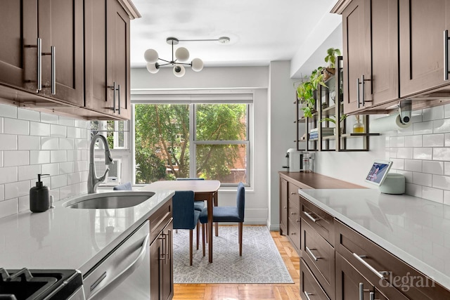 130 Saint Edwards St Unit 2C, New York City, NY 11201 - kitchen featuring stainless steel appliances, a sink, backsplash, and dark brown cabinetry