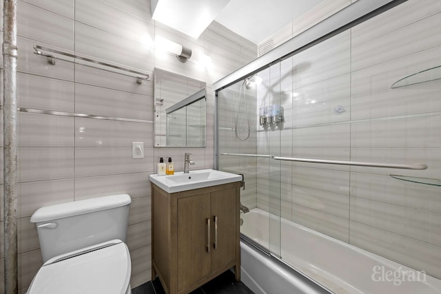 130 Saint Edwards St Unit 2C, New York City, NY 11201 - full bathroom with vanity, toilet, enclosed tub / shower combo, and tile walls