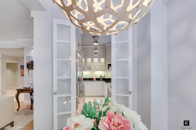 440 E 56th St Unit 1-G, New York City, NY 10022 - bathroom with backsplash, a chandelier, and crown molding