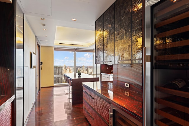 80 Columbus Cir Unit 71Ab, New York City, NY 10023 - bar area featuring a wall of windows, beverage cooler, a raised ceiling, and recessed lighting
