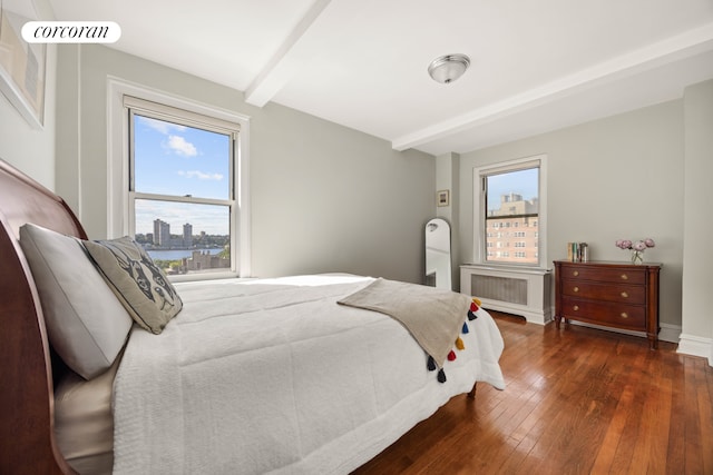304 W 75th St Unit 9H, New York City, NY 10023 - bedroom with beamed ceiling, radiator, dark wood-style floors, and a city view