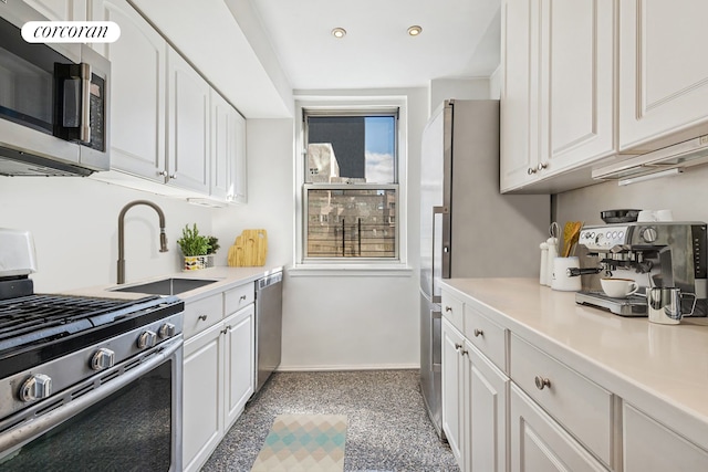 200 E 58th St Unit 17H, New York City, NY 10022 - kitchen with stainless steel appliances, white cabinets, a sink, baseboards, and recessed lighting