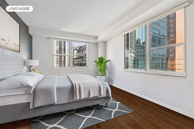 200 E 58th St Unit 17H, New York City, NY 10022 - bedroom with wood finished floors and a view of city