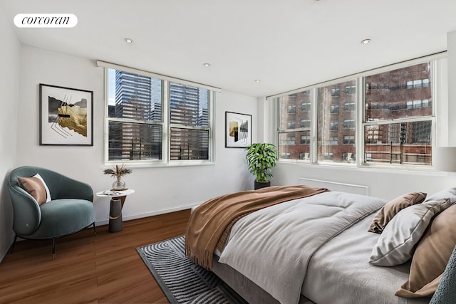 200 E 58th St Unit 17H, New York City, NY 10022 - bedroom featuring wood finished floors, multiple windows, and recessed lighting