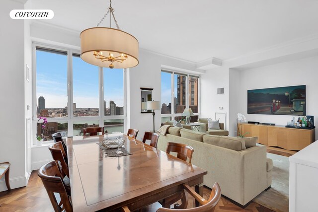 351 E 51st St Unit Ph7A, New York City, NY 10022 - dining area featuring a chandelier and ornamental molding