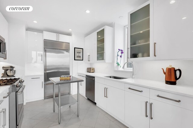 351 E 51st St Unit Ph7A, New York City, NY 10022 - kitchen featuring appliances with stainless steel finishes, white cabinetry, light countertops, and recessed lighting