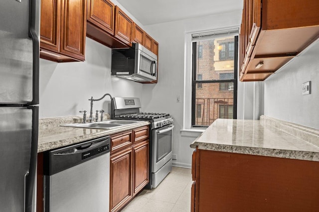 3656 Johnson Ave Unit 4G, New York City, NY 10463 - kitchen with appliances with stainless steel finishes, a sink, brown cabinetry, and light tile patterned floors