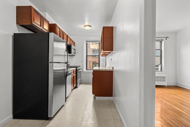 3656 Johnson Ave Unit 4G, New York City, NY 10463 - kitchen featuring stainless steel appliances, baseboards, plenty of natural light, and radiator