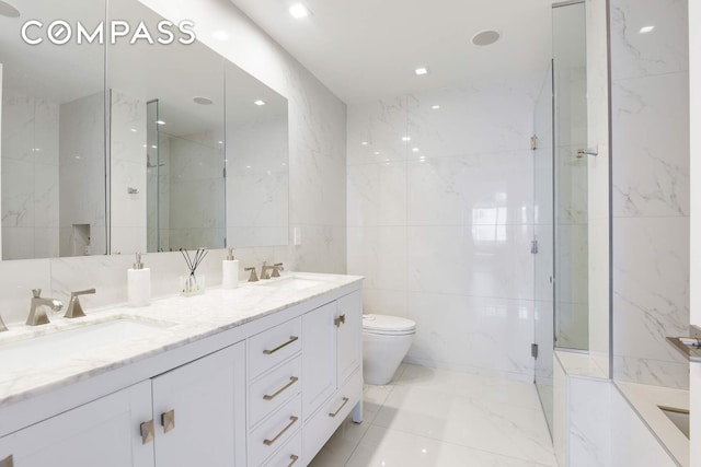 201 E 80th St Unit 16E, New York City, NY 10075 - full bath featuring tile walls, double vanity, marble finish flooring, a marble finish shower, and toilet