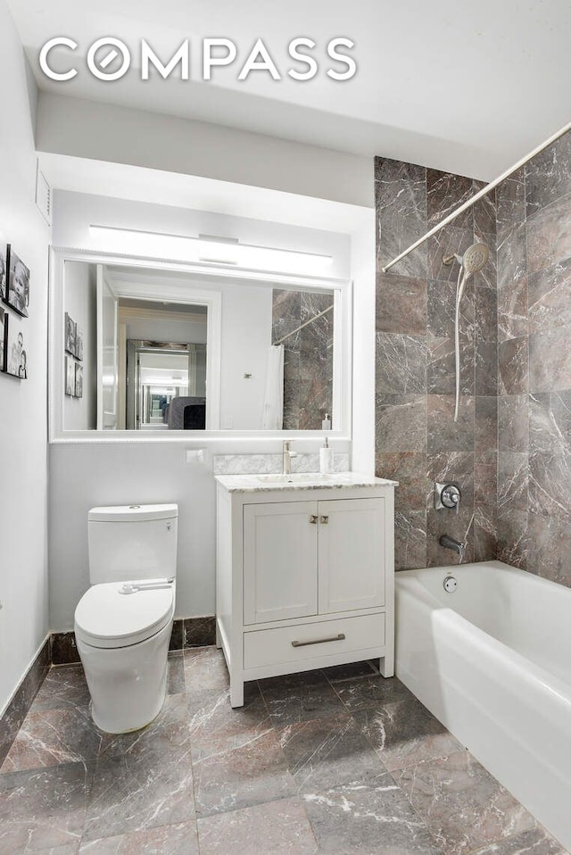 201 E 80th St Unit 16E, New York City, NY 10075 - full bathroom featuring vanity, tub / shower combination, toilet, baseboards, and marble finish floors
