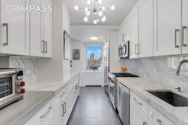 201 E 80th St Unit 16E, New York City, NY 10075 - kitchen featuring a sink, appliances with stainless steel finishes, white cabinetry, and backsplash