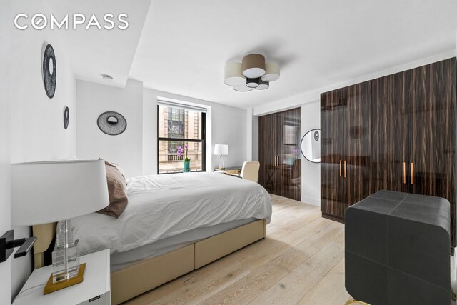 201 W 74th St Unit 8G, New York City, NY 10023 - bedroom featuring light wood-style floors