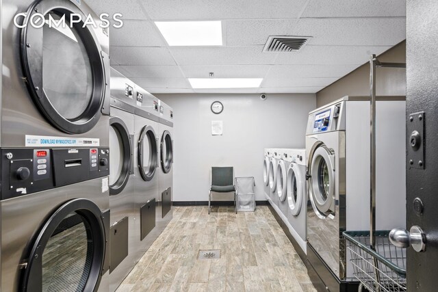201 W 74th St Unit 8G, New York City, NY 10023 - shared laundry featuring washing machine and clothes dryer, light wood-type flooring, and baseboards