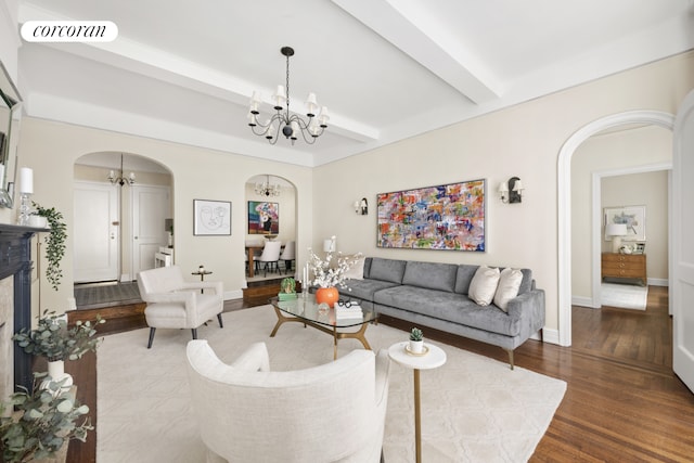 125 E 74th St Unit 2B, New York City, NY 10021 - living room featuring a chandelier, arched walkways, wood finished floors, beamed ceiling, and baseboards