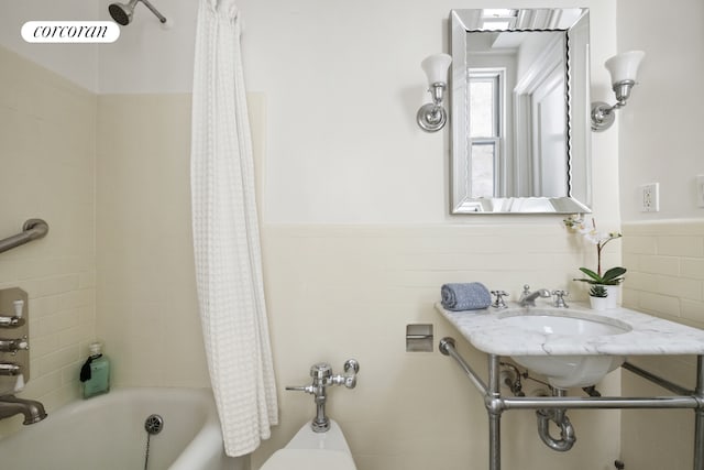 125 E 74th St Unit 2B, New York City, NY 10021 - bathroom featuring shower / bathtub combination with curtain and wainscoting