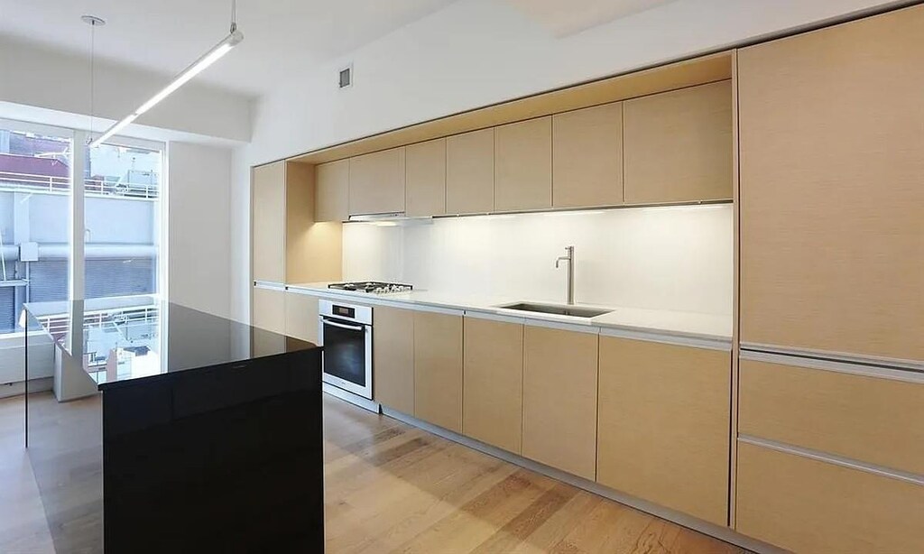 459 W 18th St Unit 2, New York City, NY 10011 - kitchen featuring a sink, oven, gas cooktop, light wood-type flooring, and cream cabinetry