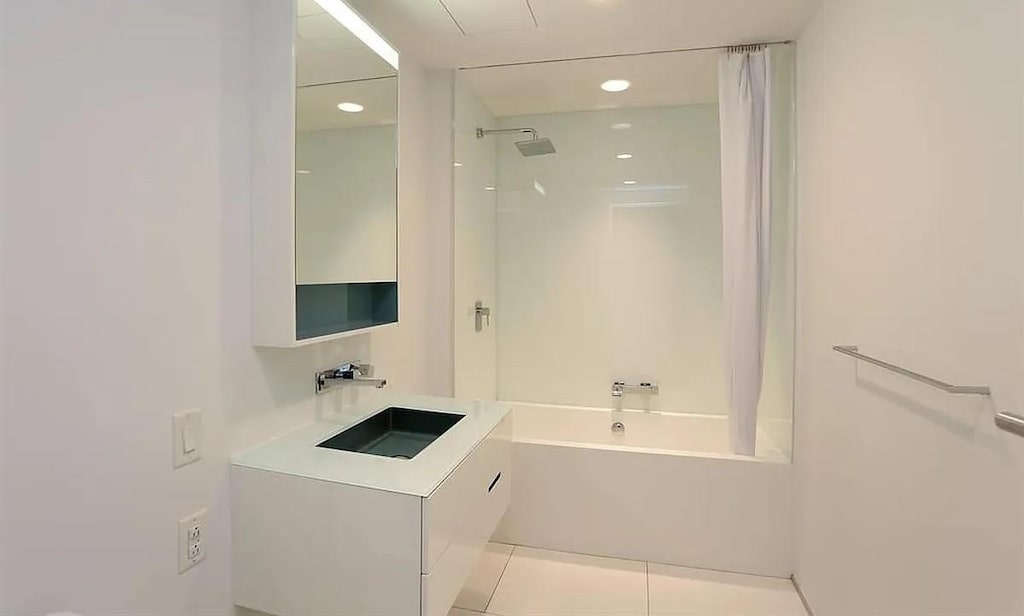 459 W 18th St Unit 2, New York City, NY 10011 - bathroom with shower / tub combo, tile patterned flooring, vanity, and recessed lighting