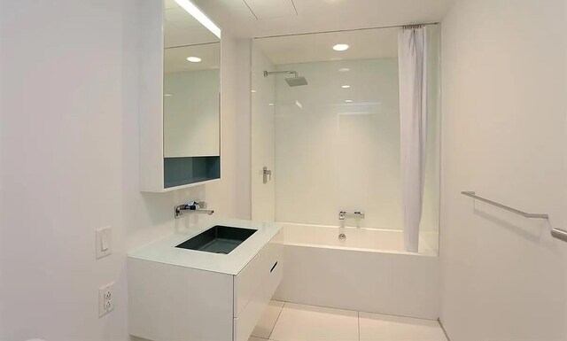 459 W 18th St Unit 2, New York City, NY 10011 - bathroom with shower / tub combo, tile patterned flooring, vanity, and recessed lighting
