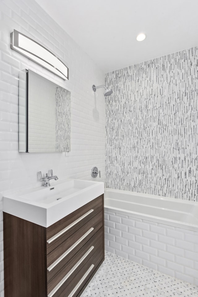 129 W 131st St Unit 1A, New York City, NY 10027 - full bathroom with tile walls, vanity, and tiled shower / bath combo