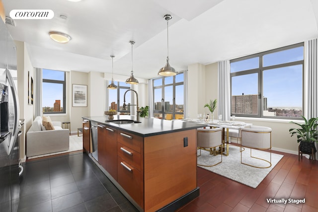 1485 5th Ave Unit 19C, New York City, NY 10035 - kitchen featuring a center island with sink, modern cabinets, dark wood-style flooring, open floor plan, and decorative light fixtures