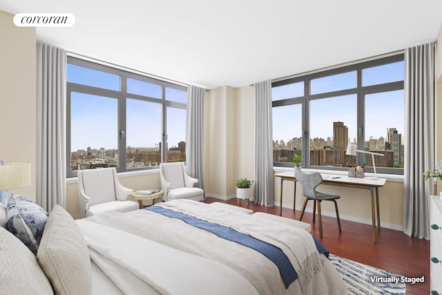 1485 5th Ave Unit 19C, New York City, NY 10035 - bedroom featuring a skyline view and wood finished floors