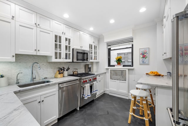 45 E 85th St Unit 7E, New York City, NY 10028 - kitchen featuring a sink, stainless steel appliances, ornamental molding, white cabinetry, and backsplash