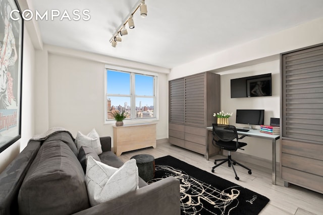 142 E 16th St Unit 22B, New York City, NY 10003 - home office with light wood-style flooring and rail lighting