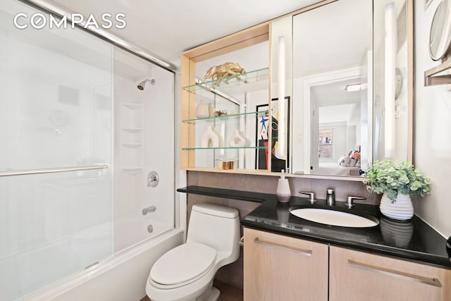 142 E 16th St Unit 22B, New York City, NY 10003 - ensuite bathroom with vanity, toilet, and bath / shower combo with glass door