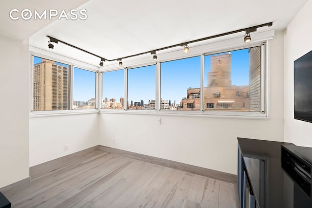 142 E 16th St Unit 22B, New York City, NY 10003 - unfurnished room with rail lighting, light wood-style flooring, and baseboards