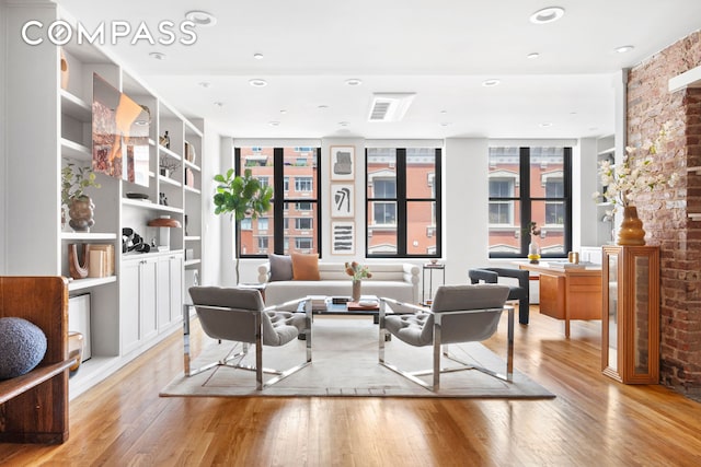 120 W 20th St Ph, Ph, New York City, NY 10011 - living area with light wood finished floors, built in shelves, and recessed lighting