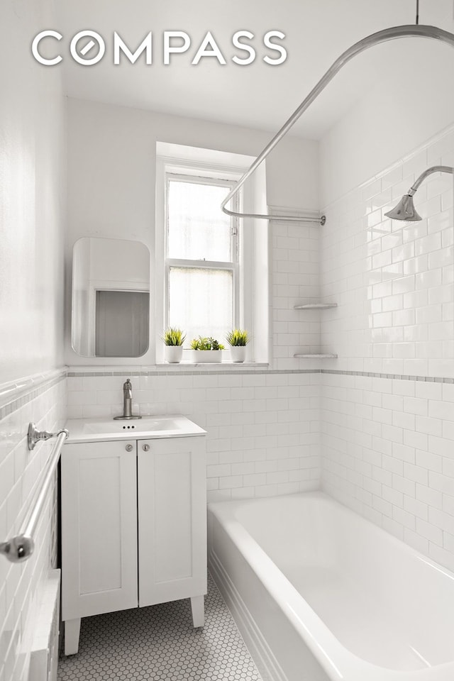 35-47 80th St Unit 2, New York City, NY 11372 - bathroom with tile walls, tile patterned flooring, vanity, and washtub / shower combination