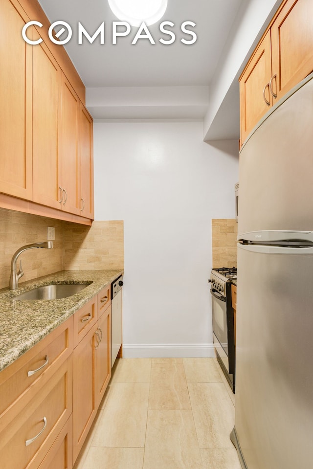 305 E 40th St Unit 14V, New York City, NY 10016 - kitchen with freestanding refrigerator, gas range oven, backsplash, light stone counters, and dishwasher