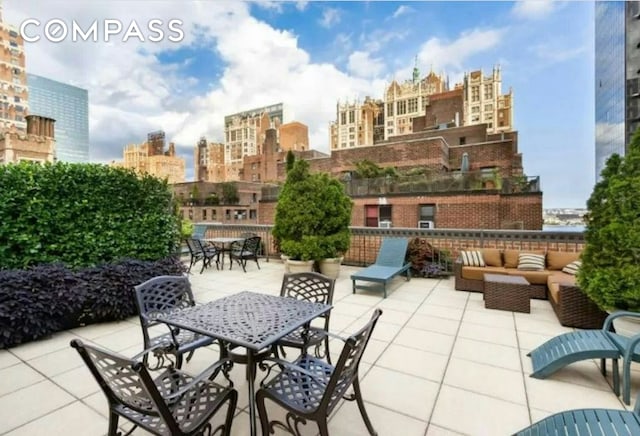 305 E 40th St Unit 14V, New York City, NY 10016 - view of patio / terrace with an outdoor living space, a skyline view, and outdoor dining area