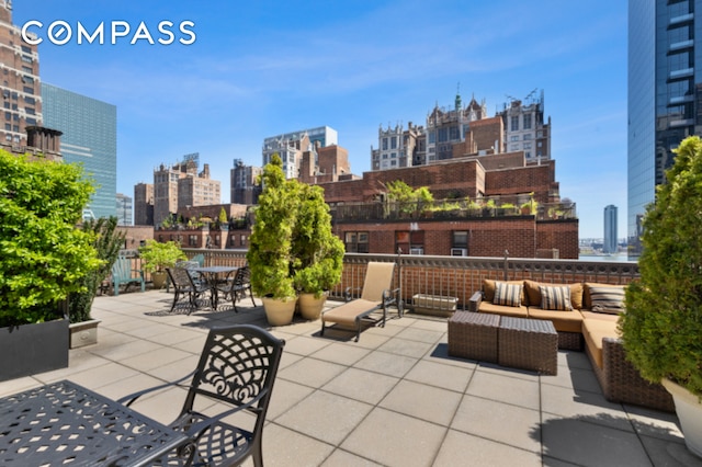 305 E 40th St Unit 14V, New York City, NY 10016 - view of patio with a view of skyline, an outdoor living space, and outdoor dining space