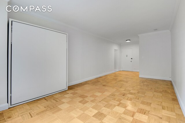 305 E 40th St Unit 14V, New York City, NY 10016 - empty room with baseboards and crown molding