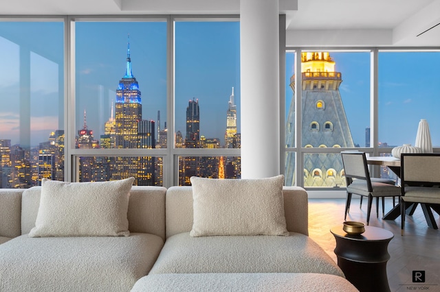 23 E 22nd St Unit 55, New York City, NY 10010 - living area featuring a view of skyline, floor to ceiling windows, plenty of natural light, and wood finished floors