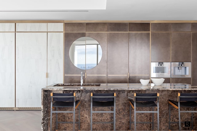 23 E 22nd St Unit 55, New York City, NY 10010 - kitchen featuring a sink and dark stone counters
