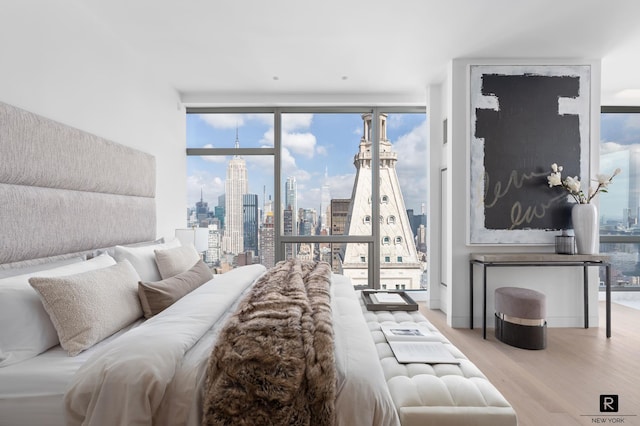 23 E 22nd St Unit 55, New York City, NY 10010 - bedroom with wood finished floors and a view of skyline