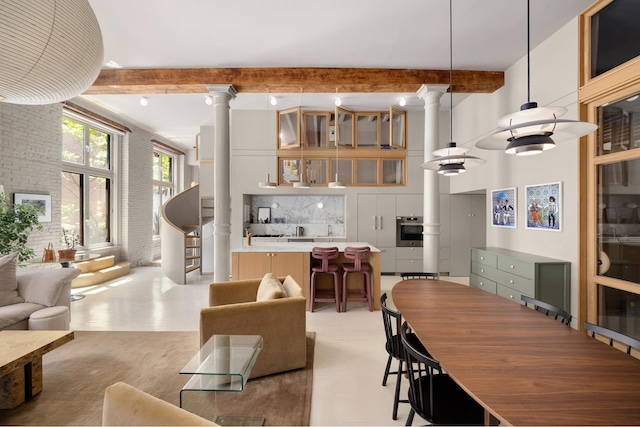 132 Greene St Unit 3R, New York City, NY 10012 - living room with ornate columns and beamed ceiling
