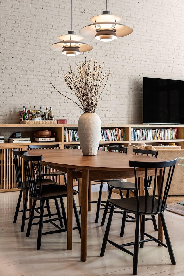 132 Greene St Unit 3R, New York City, NY 10012 - dining area featuring brick wall