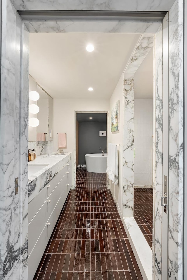 132 Greene St Unit 3R, New York City, NY 10012 - full bathroom featuring a freestanding tub, vanity, and recessed lighting