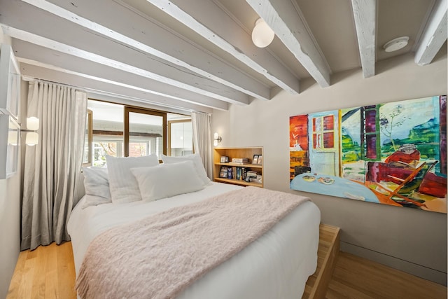 132 Greene St Unit 3R, New York City, NY 10012 - bedroom featuring wood finished floors and beamed ceiling