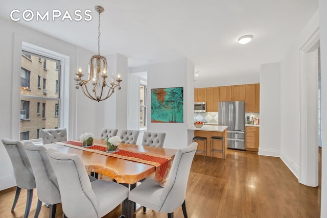 800 Riverside Dr Unit 2E, New York City, NY 10032 - dining space featuring a chandelier and wood finished floors
